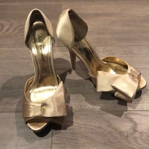 Gold heels with bow detail
